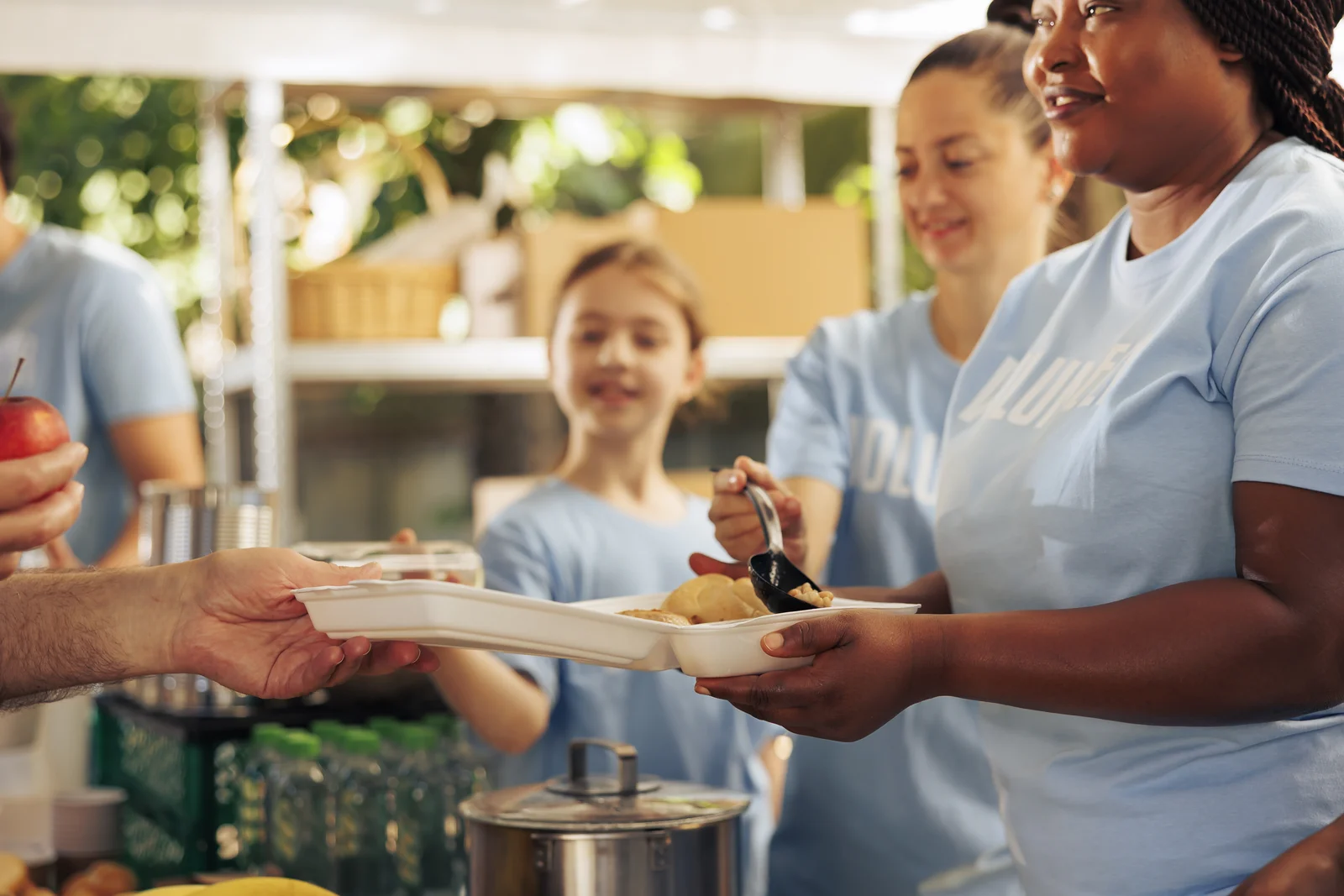 Volunteers serving meals at a community kitchen